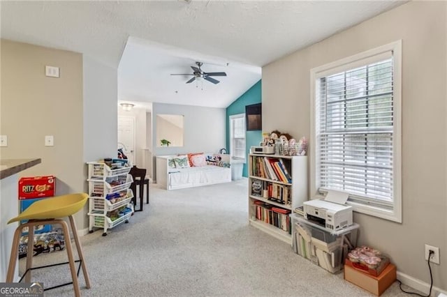 playroom with ceiling fan, lofted ceiling, and carpet floors