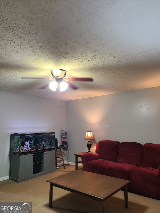 living room featuring a textured ceiling, light colored carpet, and ceiling fan