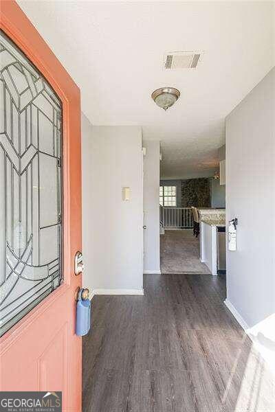 entryway with dark hardwood / wood-style floors