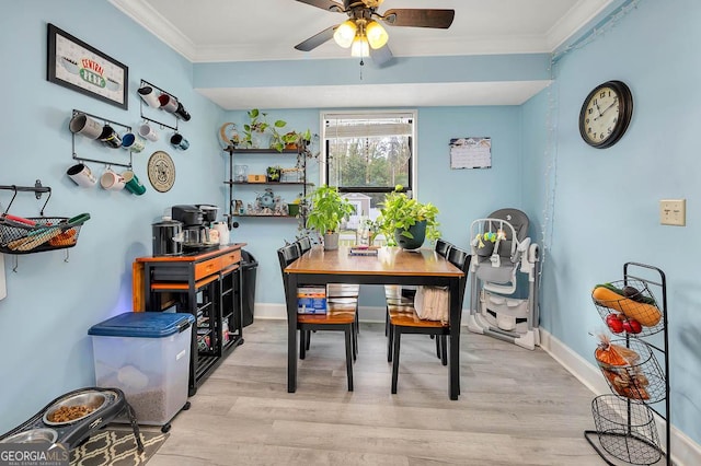 dining area with ceiling fan, baseboards, wood finished floors, and ornamental molding