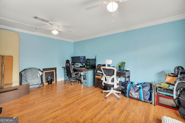 office with visible vents, wood finished floors, a ceiling fan, and ornamental molding