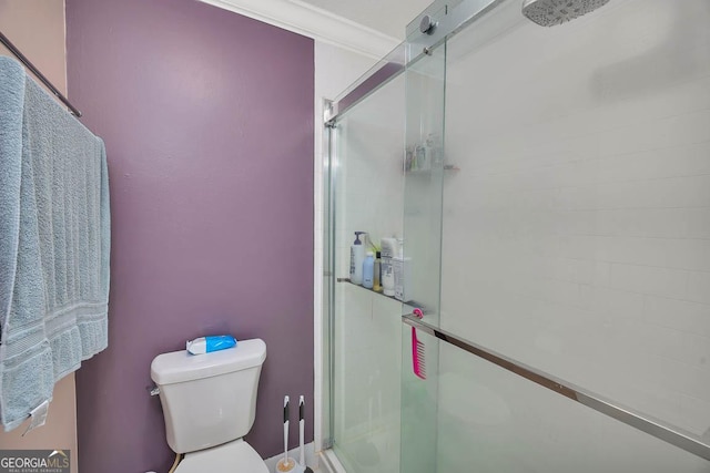 bathroom with a shower stall and toilet