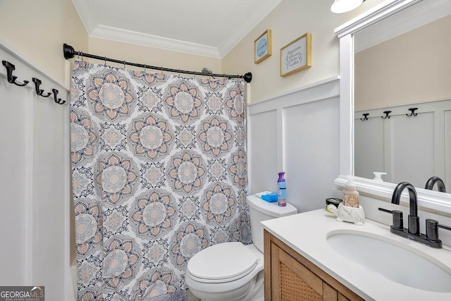 bathroom with vanity, a decorative wall, toilet, and ornamental molding