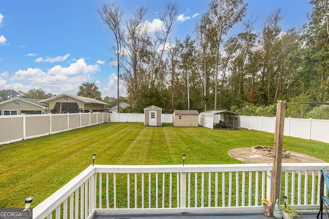 view of yard featuring an outbuilding, a storage shed, and a fenced backyard