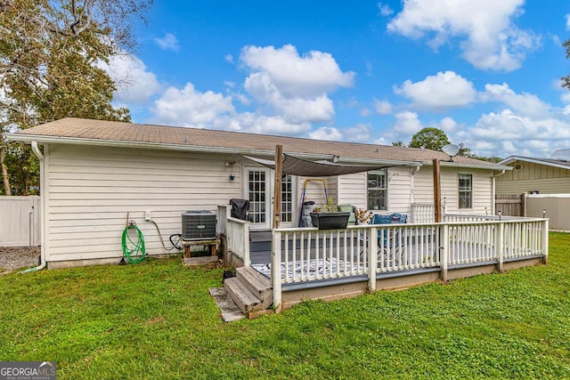 back of house featuring cooling unit, a lawn, a deck, and fence