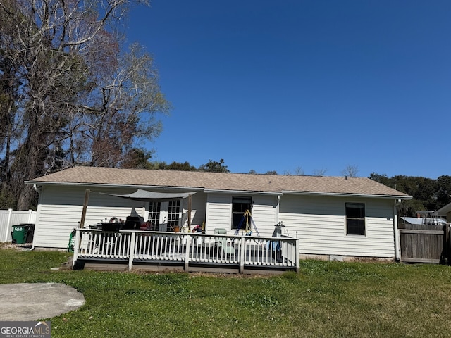 back of house featuring a deck, a yard, and fence