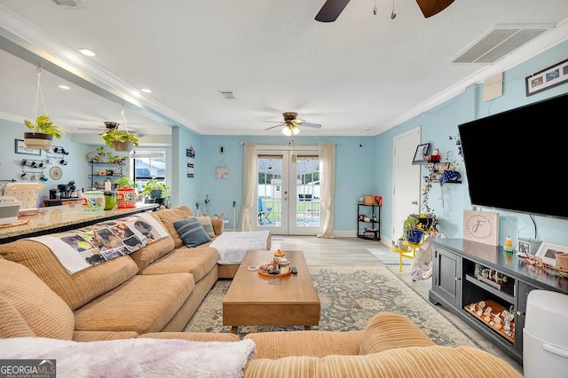 living area with a ceiling fan, crown molding, french doors, and visible vents