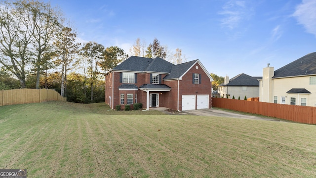 view of front of property with a front yard and a garage