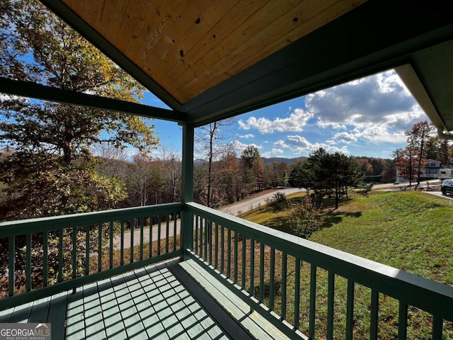 wooden deck featuring a yard