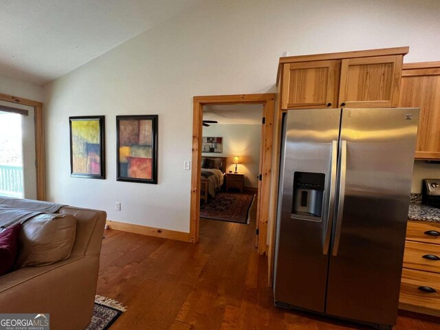 interior space featuring dark hardwood / wood-style flooring and lofted ceiling