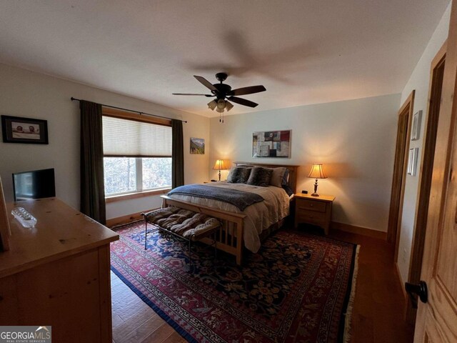 bedroom with ceiling fan and dark hardwood / wood-style floors