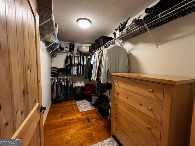 walk in closet featuring dark hardwood / wood-style floors