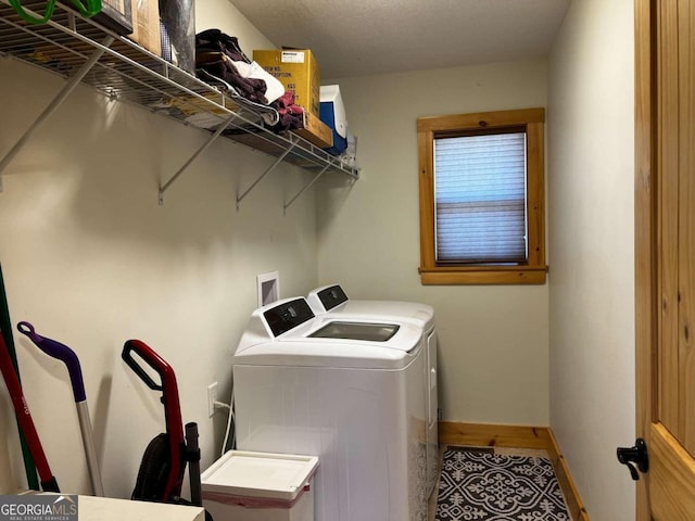 clothes washing area with washing machine and dryer