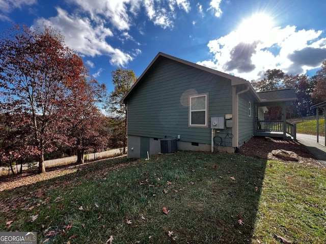 view of property exterior with central AC unit and a lawn