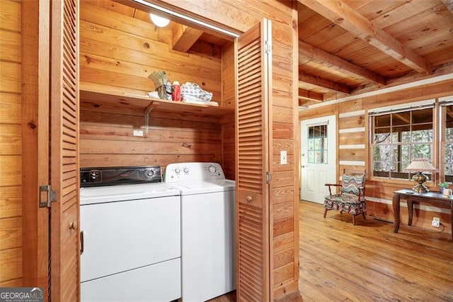 washroom featuring wood walls, wooden ceiling, light hardwood / wood-style flooring, and washer and clothes dryer