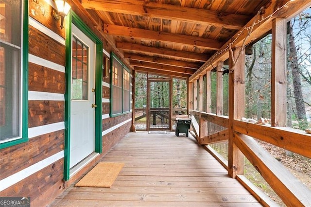 unfurnished sunroom with lofted ceiling and wood ceiling