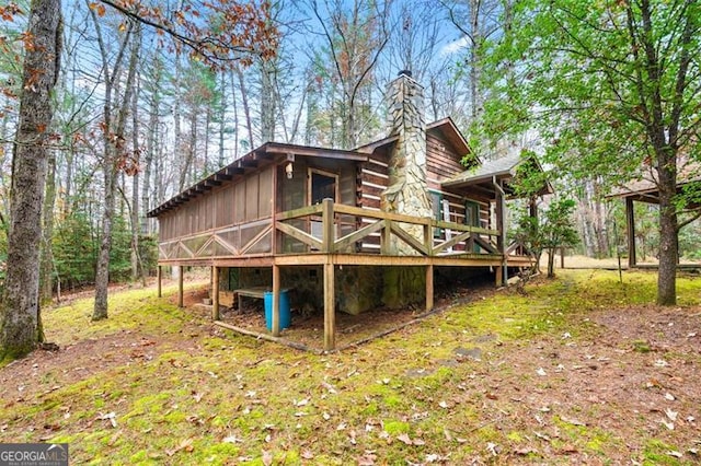 rear view of property with a wooden deck