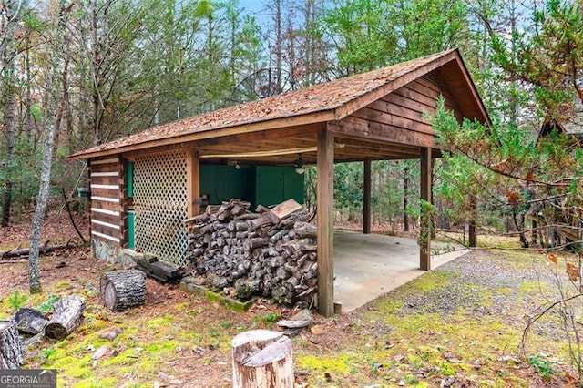 view of patio featuring an outbuilding and a carport