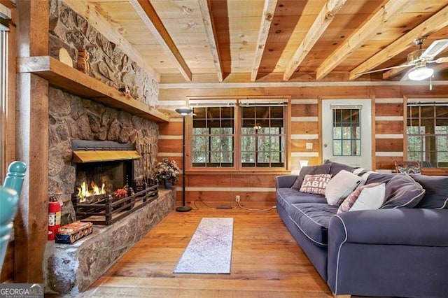 living room with hardwood / wood-style floors, plenty of natural light, a fireplace, and wood ceiling