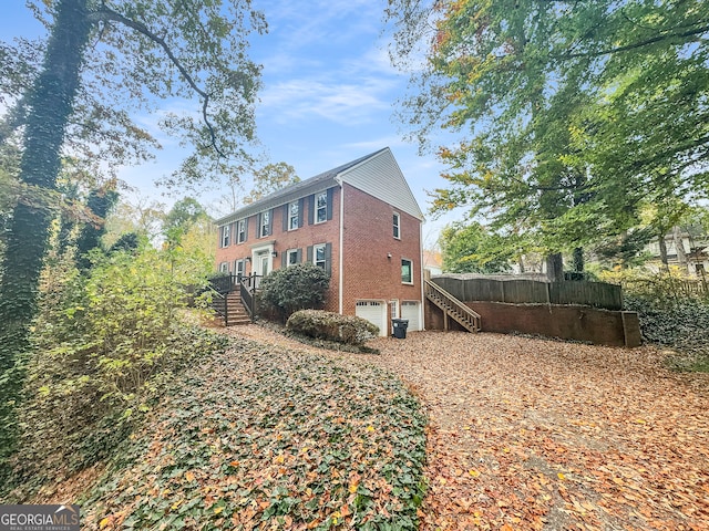 view of side of home featuring a garage