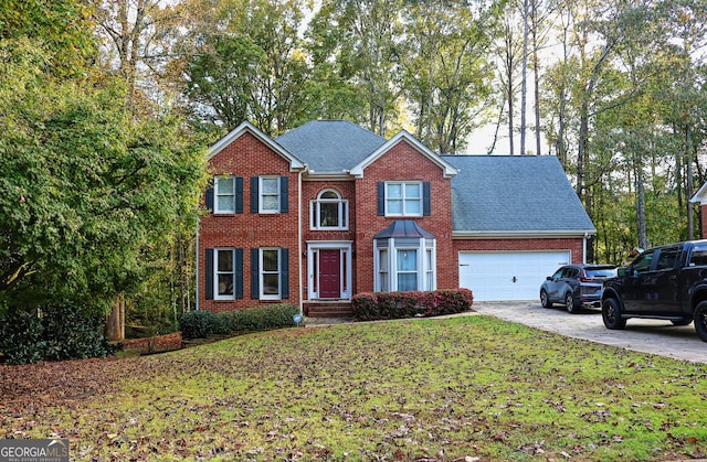 view of front of home with a garage and a front lawn