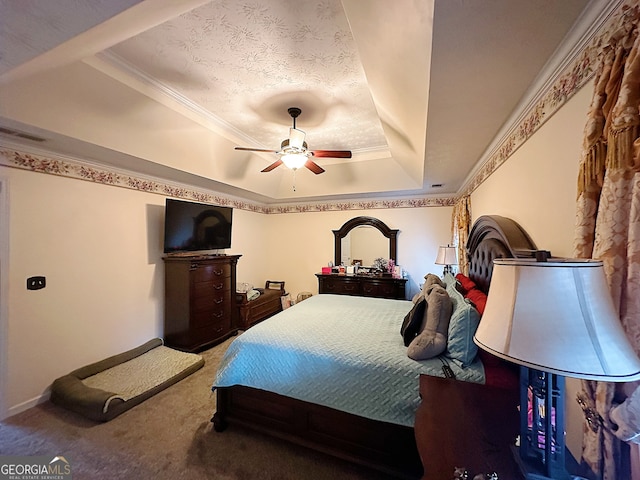 carpeted bedroom with ceiling fan, a raised ceiling, and ornamental molding