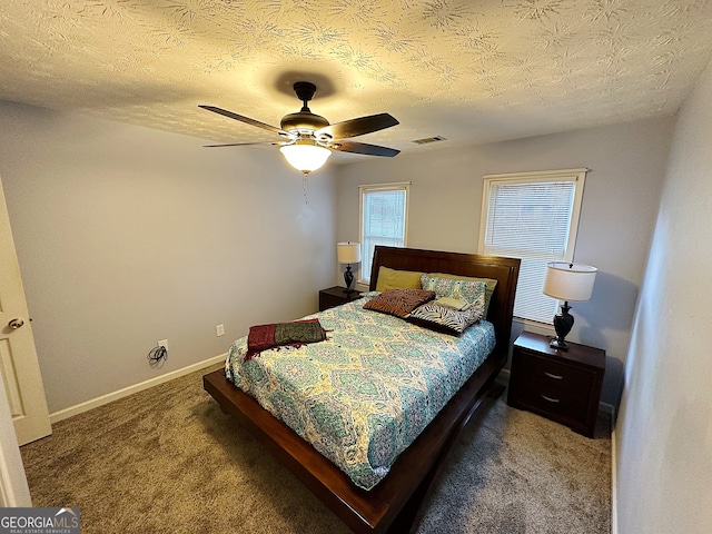 bedroom featuring ceiling fan, a textured ceiling, and carpet floors