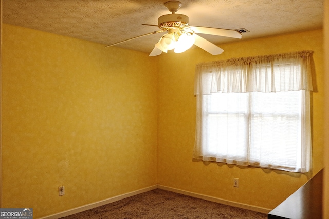 carpeted empty room with a textured ceiling and ceiling fan