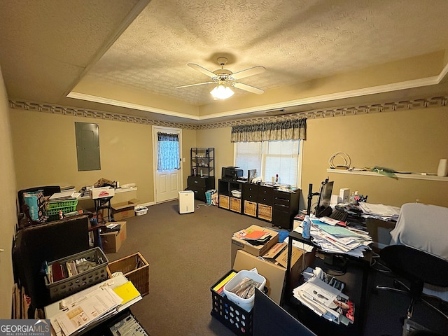 carpeted home office featuring ornamental molding, ceiling fan, a textured ceiling, a tray ceiling, and electric panel