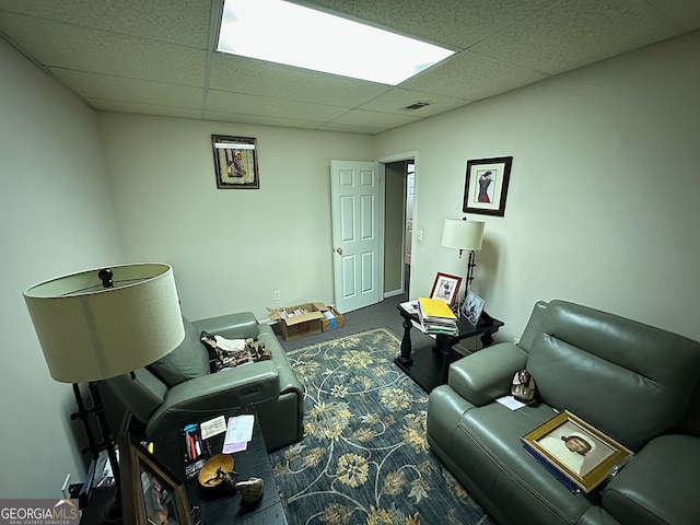 interior space with a paneled ceiling