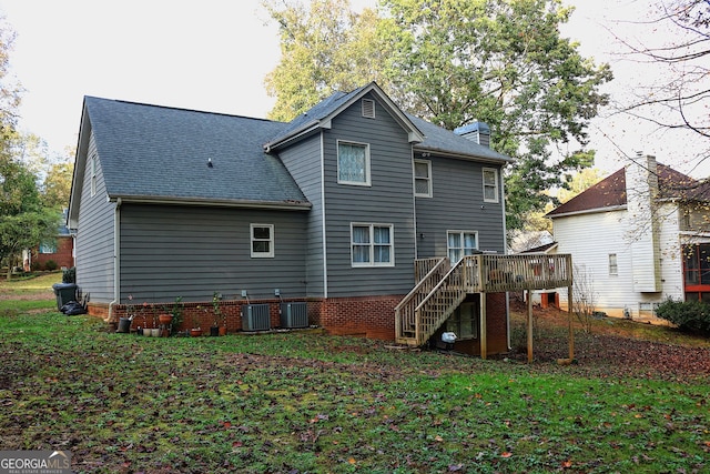 rear view of house with cooling unit, a yard, and a deck