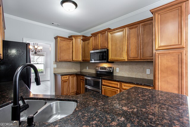 kitchen featuring stainless steel appliances, dark stone countertops, sink, and ornamental molding