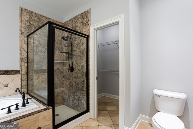 bathroom featuring toilet, tile patterned floors, and plus walk in shower