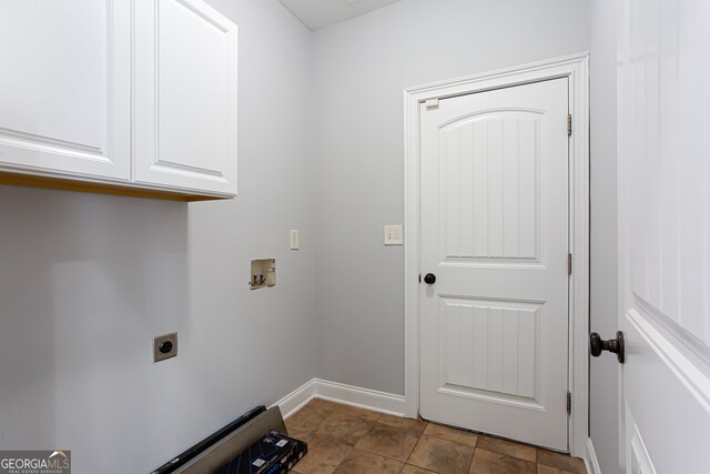 washroom with cabinets, washer hookup, tile patterned flooring, and electric dryer hookup