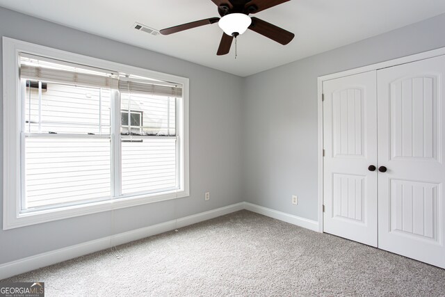 spare room with carpet floors and ceiling fan