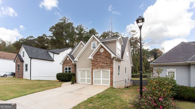 view of front of property with a garage and a front lawn