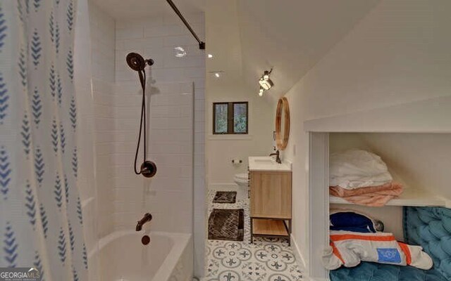 7670 Hiawassee Wilderness Trl, Hiawassee, GA 30546 - bathroom featuring vanity, shower / bath combination with curtain, baseboards, and vaulted ceiling