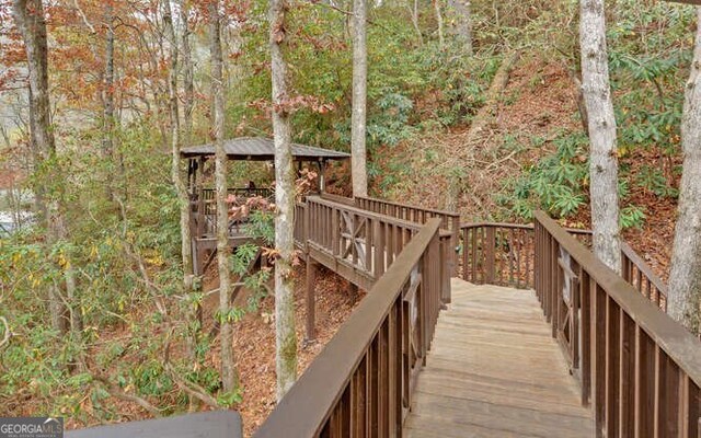 7670 Hiawassee Wilderness Trl, Hiawassee, GA 30546 - deck with a gazebo and a forest view
