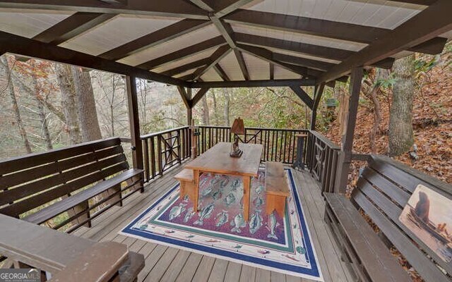 7670 Hiawassee Wilderness Trl, Hiawassee, GA 30546 - deck featuring outdoor dining area and a gazebo