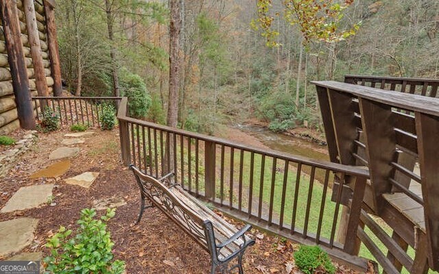 7670 Hiawassee Wilderness Trl, Hiawassee, GA 30546 - wooden terrace with a forest view