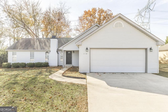 ranch-style home featuring a garage and a front lawn