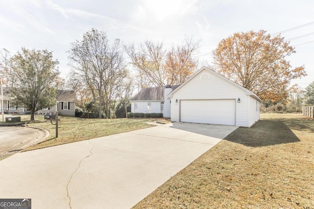 view of side of home with a lawn and a garage