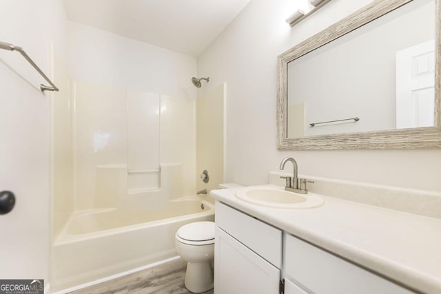 full bathroom featuring shower / washtub combination, vanity, wood-type flooring, and toilet