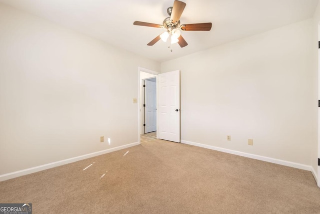 carpeted spare room with ceiling fan