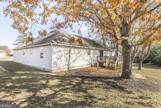 view of home's exterior featuring a lawn, central AC unit, and a deck