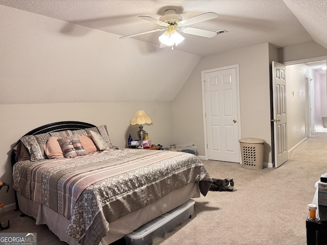 carpeted bedroom with ceiling fan, a textured ceiling, and vaulted ceiling