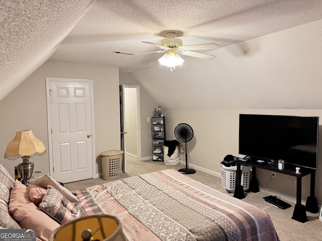 bedroom with ceiling fan, a textured ceiling, vaulted ceiling, and light carpet