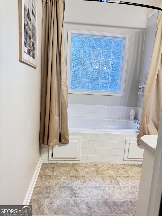 bathroom featuring a relaxing tiled tub