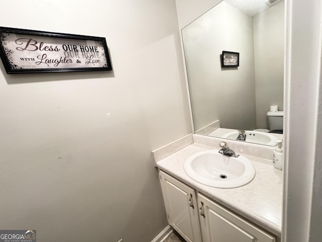 bathroom with toilet and vanity