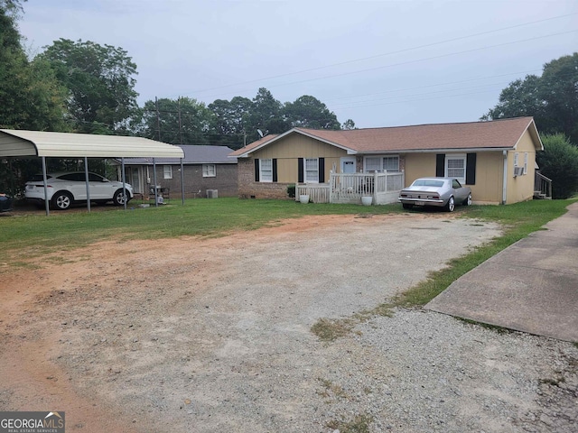 view of front of home with a front lawn and a carport